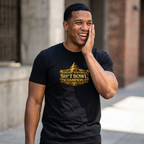 Man wearing a black t-shirt with 'Fantasy Football Sh*t Bowl Champion' text, smiling outdoors.