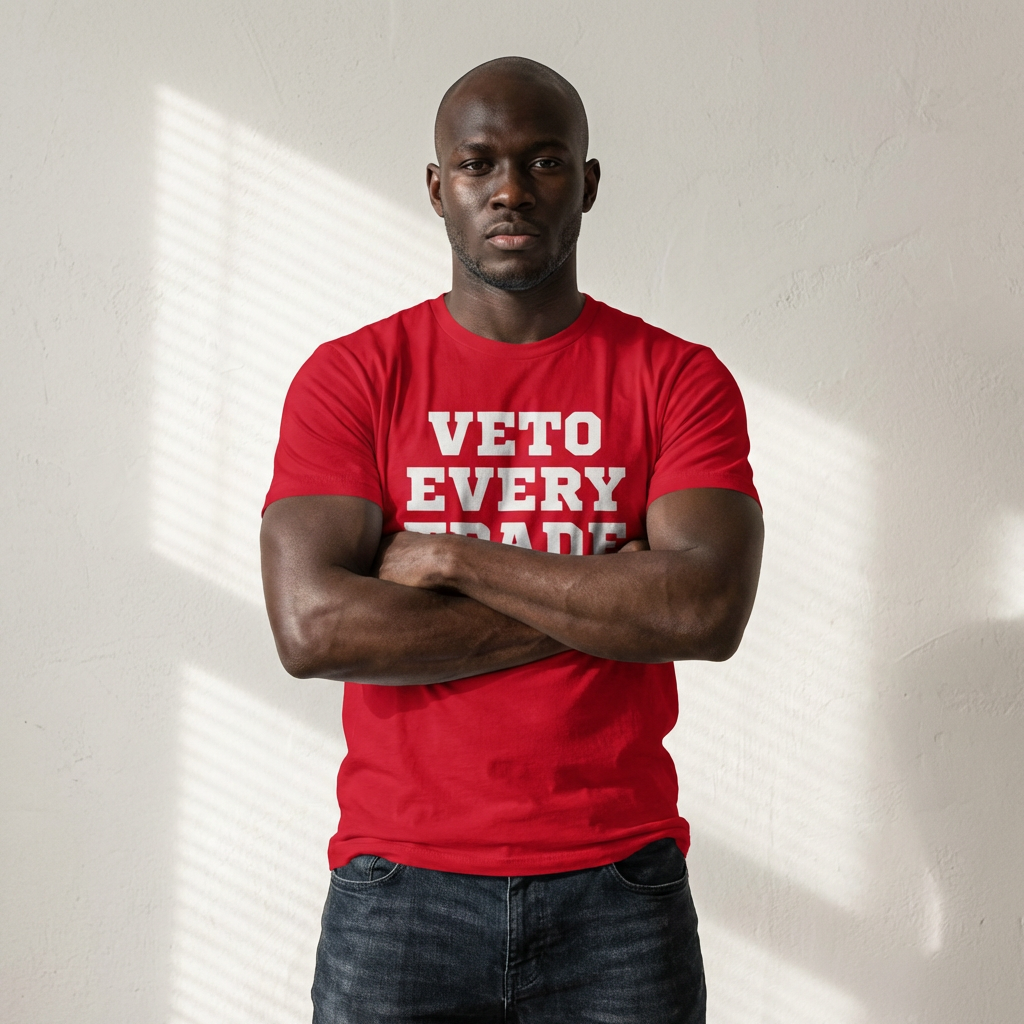 Man wearing a red t-shirt with 'VETO EVERY TRADE' text against a light background