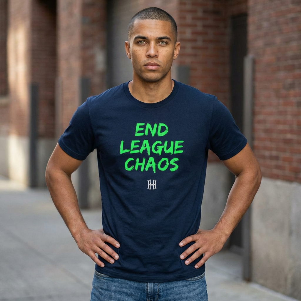 Man wearing a navy blue t-shirt with green text 'END LEAGUE CHAOS' in an urban setting.